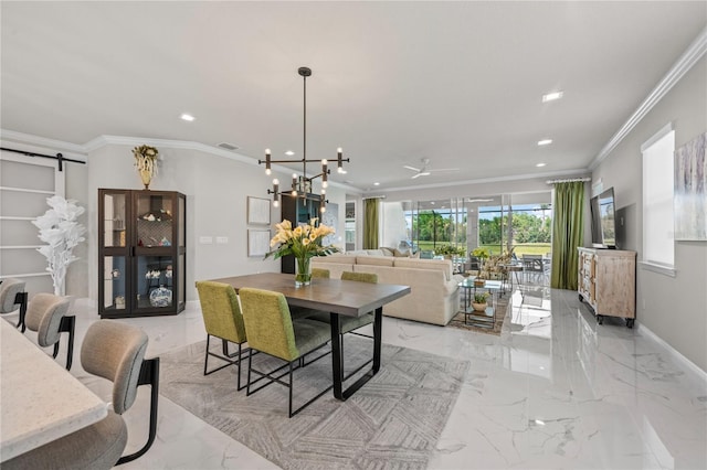 dining space with a barn door, a chandelier, and ornamental molding