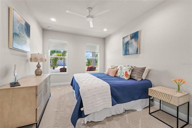 bedroom featuring light carpet and ceiling fan