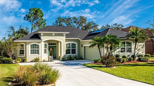 view of front of property featuring a front yard and a garage