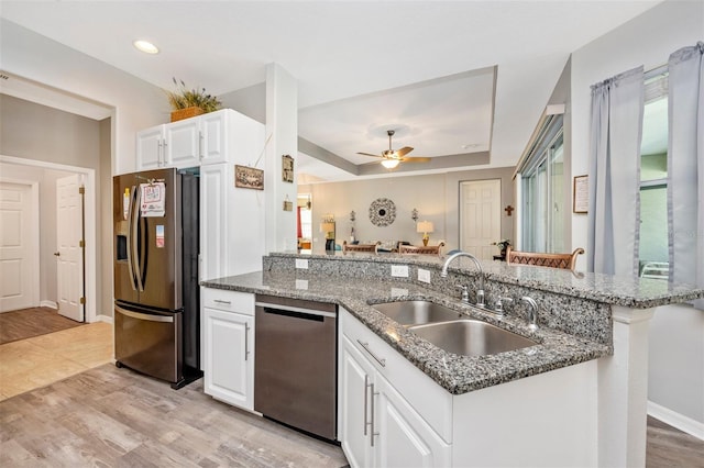 kitchen featuring light hardwood / wood-style floors, sink, white cabinetry, and stainless steel appliances