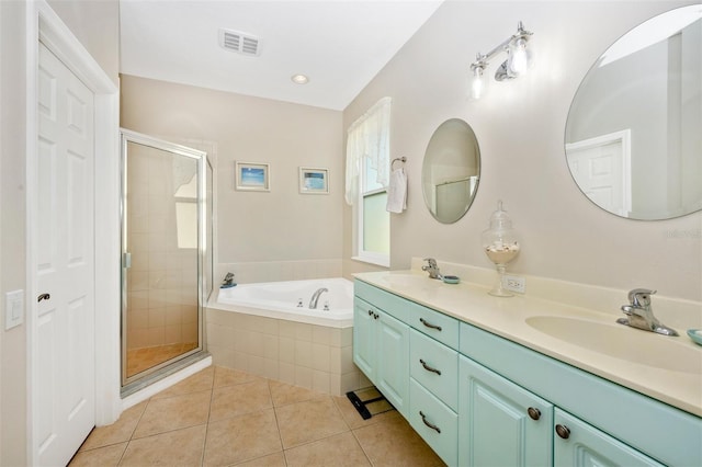 bathroom featuring vanity, tile patterned flooring, and plus walk in shower