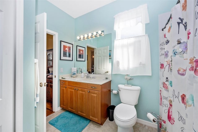 bathroom with walk in shower, vanity, and toilet