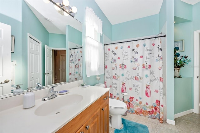 bathroom featuring tile patterned floors, vanity, and toilet