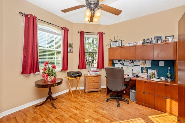 home office featuring ceiling fan and light hardwood / wood-style flooring