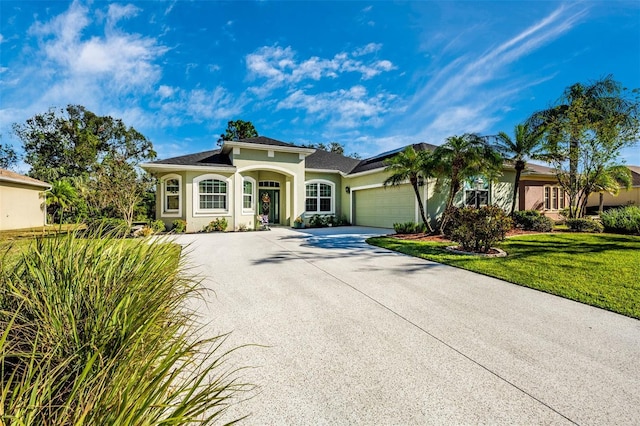 view of front of home featuring a front lawn and a garage