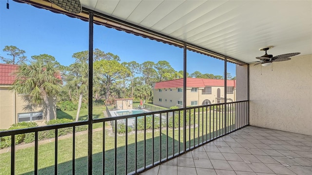 unfurnished sunroom featuring ceiling fan