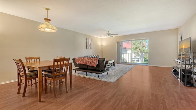 dining room with ceiling fan and hardwood / wood-style flooring