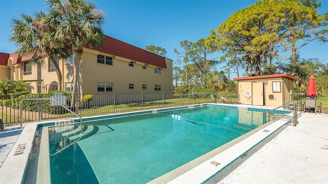 view of swimming pool featuring a storage unit