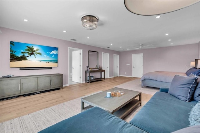 living room featuring ceiling fan and light wood-type flooring