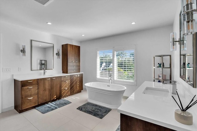 bathroom featuring tile patterned floors, vanity, and a tub to relax in