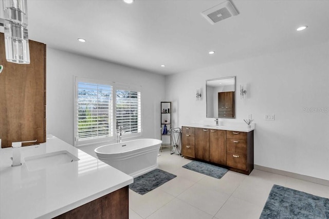 bathroom with vanity and a tub