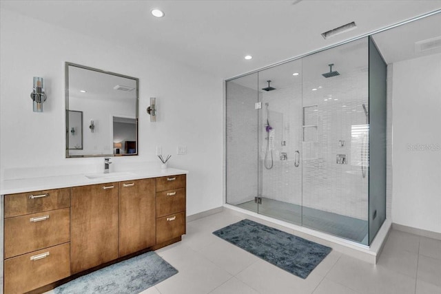 bathroom featuring a shower with door, vanity, and tile patterned flooring