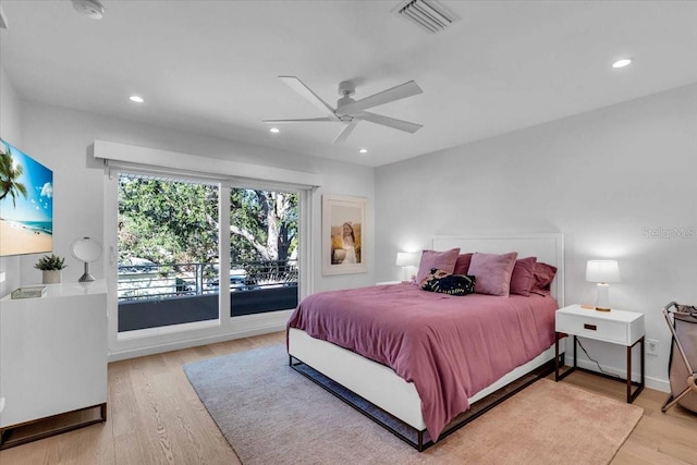 bedroom featuring access to exterior, hardwood / wood-style floors, and ceiling fan