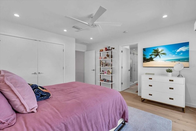 bedroom featuring ceiling fan, a closet, connected bathroom, and light hardwood / wood-style flooring