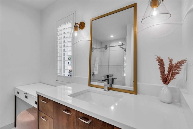 bathroom featuring vanity and a shower with door