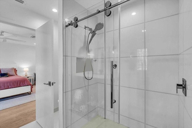 bathroom featuring hardwood / wood-style floors and a shower with door