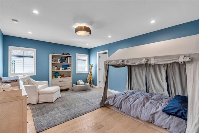 bedroom featuring light hardwood / wood-style floors and multiple windows