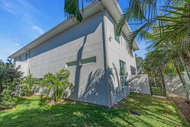 view of property exterior with a lawn