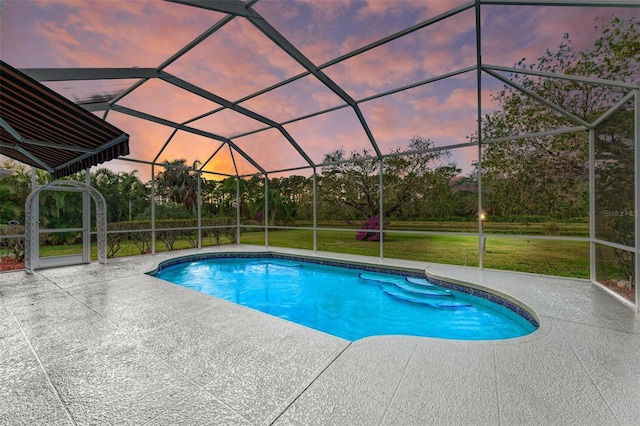 pool at dusk with a lanai, a patio area, and a lawn