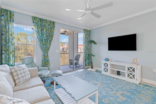 living room with a wealth of natural light, crown molding, ceiling fan, and a textured ceiling