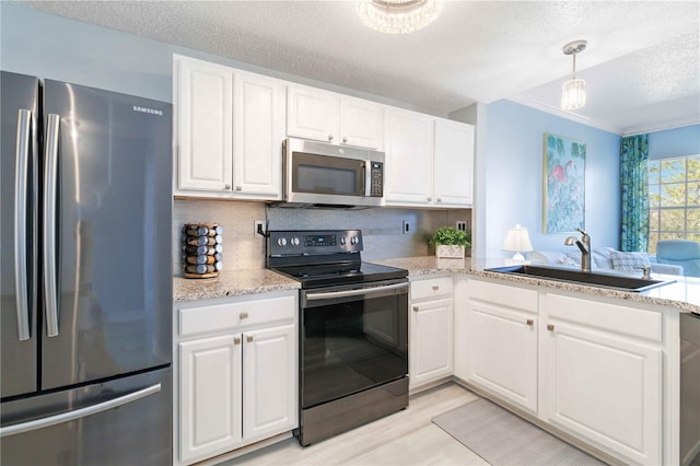 kitchen featuring white cabinetry, sink, and appliances with stainless steel finishes