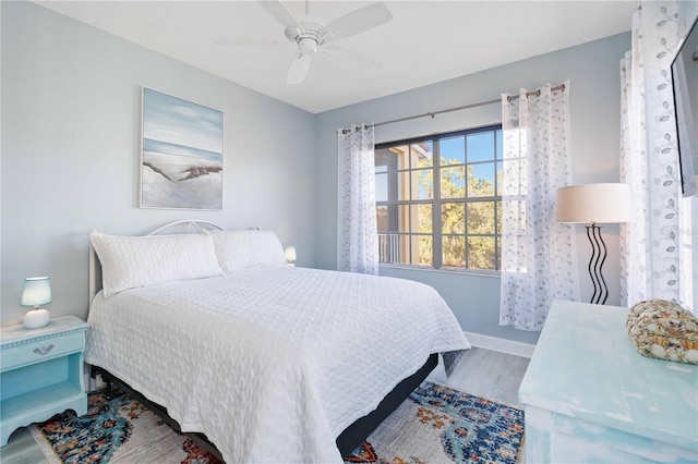 bedroom with ceiling fan and hardwood / wood-style floors