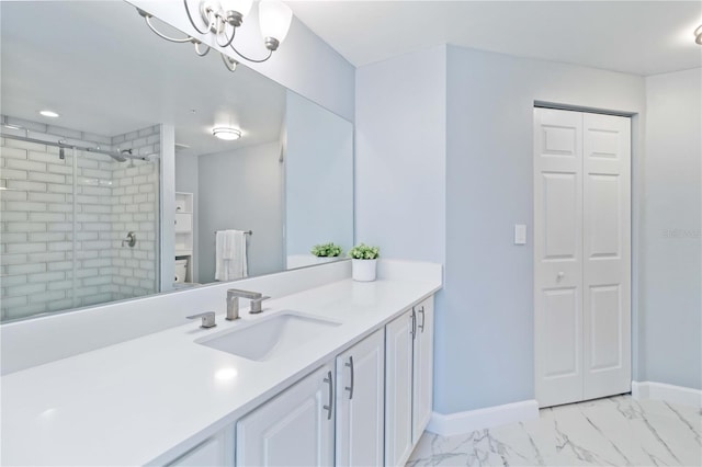 bathroom with a notable chandelier, vanity, and an enclosed shower