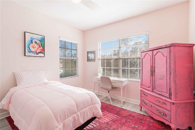 bedroom with light wood-type flooring and ceiling fan