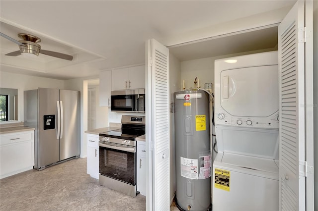 kitchen featuring stacked washing maching and dryer, stainless steel appliances, ceiling fan, water heater, and white cabinets