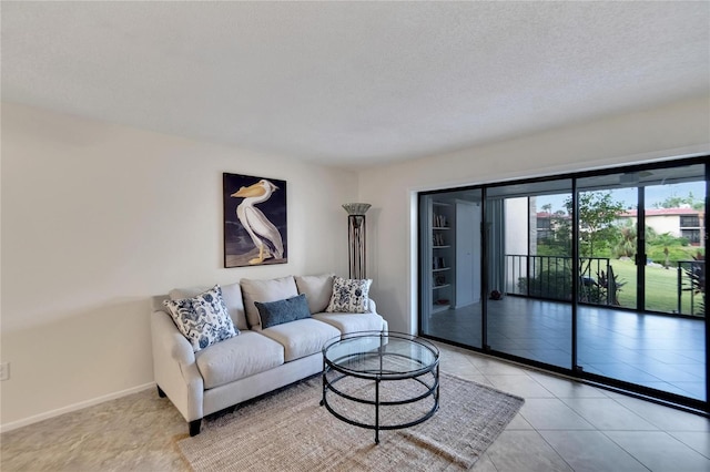 living room featuring light tile patterned flooring and a textured ceiling