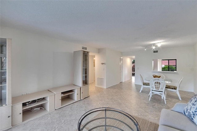 living room with a textured ceiling