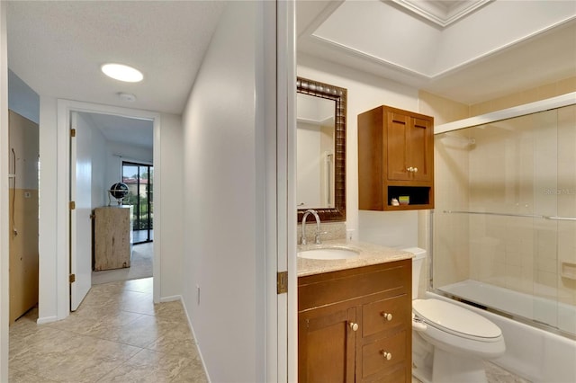 full bathroom with tile patterned floors, a textured ceiling, toilet, shower / bath combination with glass door, and vanity