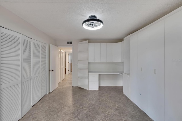 interior space featuring a textured ceiling