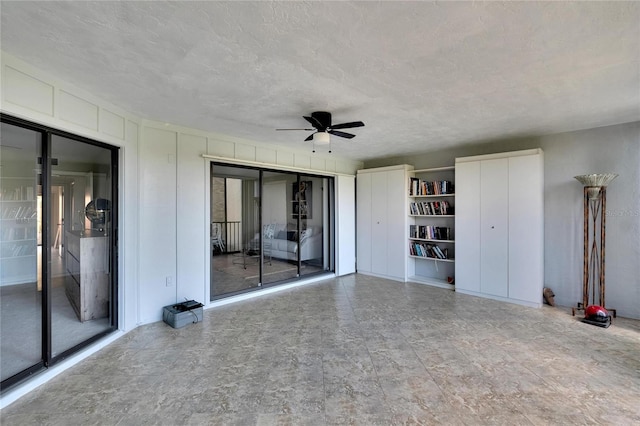 exterior space featuring ceiling fan and a textured ceiling