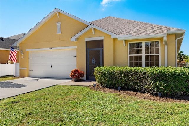 single story home featuring a garage and a front lawn