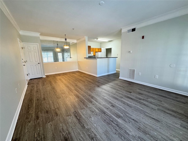 unfurnished living room featuring dark hardwood / wood-style flooring and ornamental molding