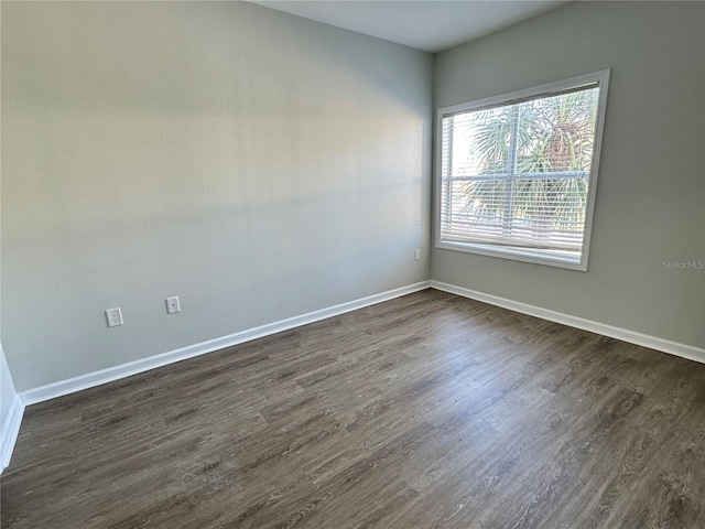 empty room with dark wood-type flooring