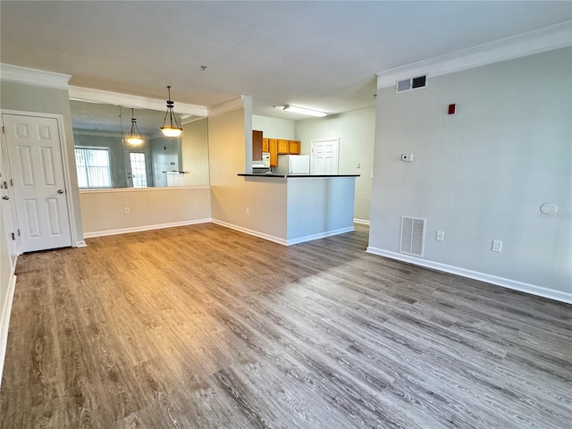 unfurnished living room featuring light wood-type flooring and ornamental molding