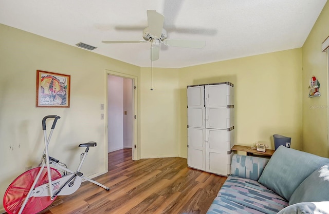 living room featuring ceiling fan and hardwood / wood-style floors