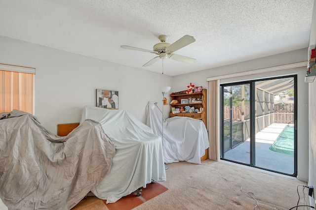 bedroom featuring access to exterior, ceiling fan, light colored carpet, and a textured ceiling