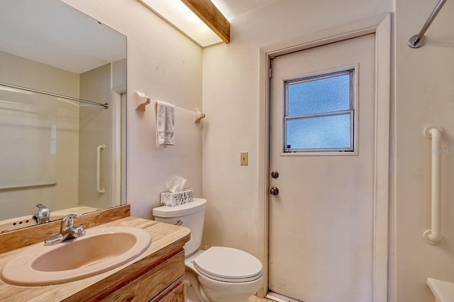 bathroom with vanity, toilet, and walk in shower