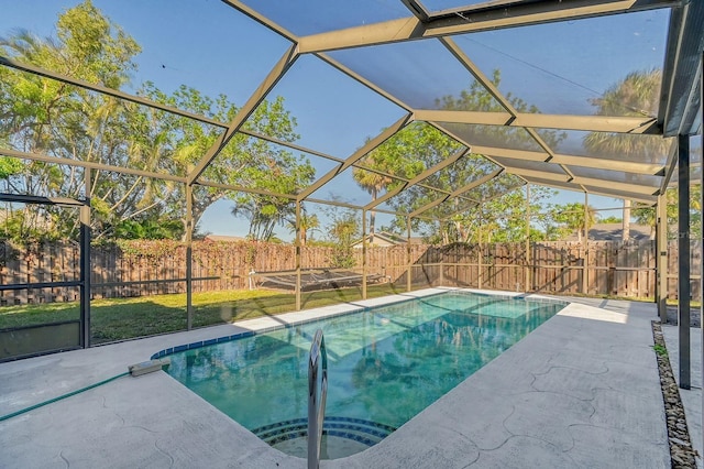 view of swimming pool with a lanai and a patio area