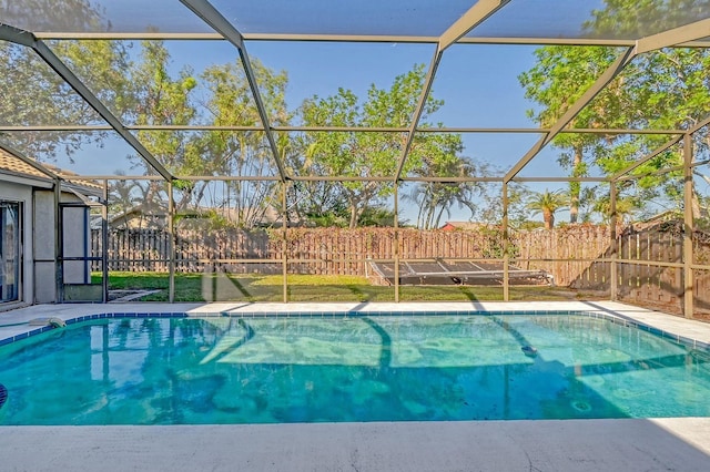 view of swimming pool with glass enclosure