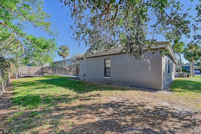 view of yard featuring central AC and a lanai