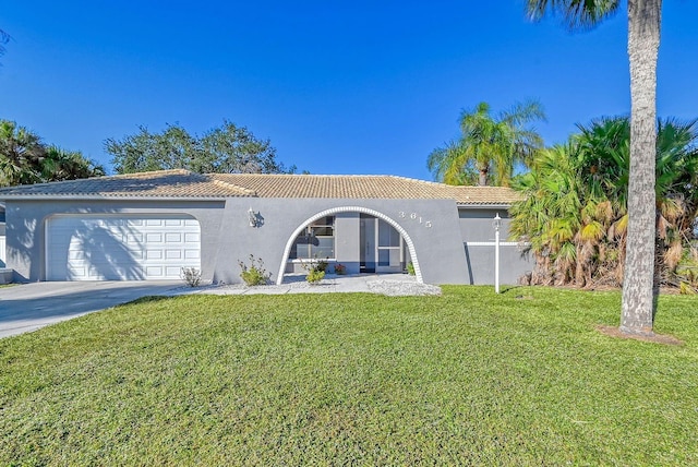 mediterranean / spanish-style house with a front yard and a garage