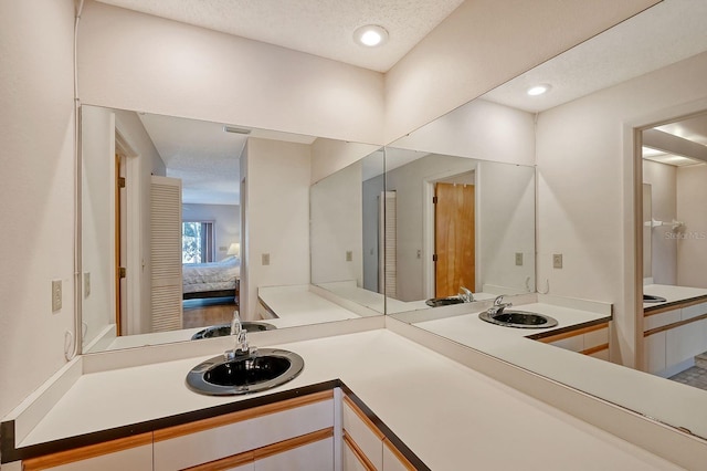 bathroom featuring vanity and a textured ceiling