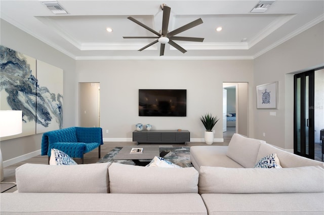 living room with wood-type flooring, ceiling fan, and ornamental molding