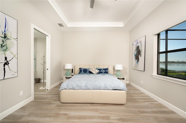 bedroom featuring ceiling fan, light wood-type flooring, and ornamental molding