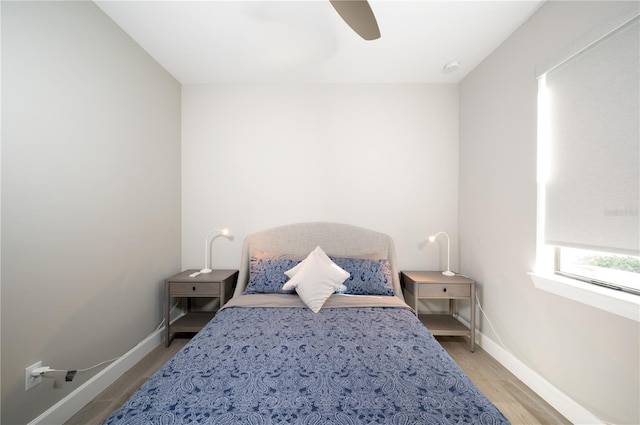 bedroom with ceiling fan and wood-type flooring