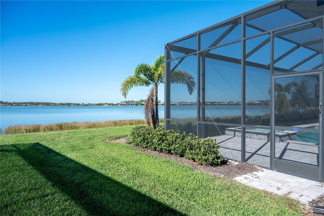 exterior space featuring a water view and glass enclosure